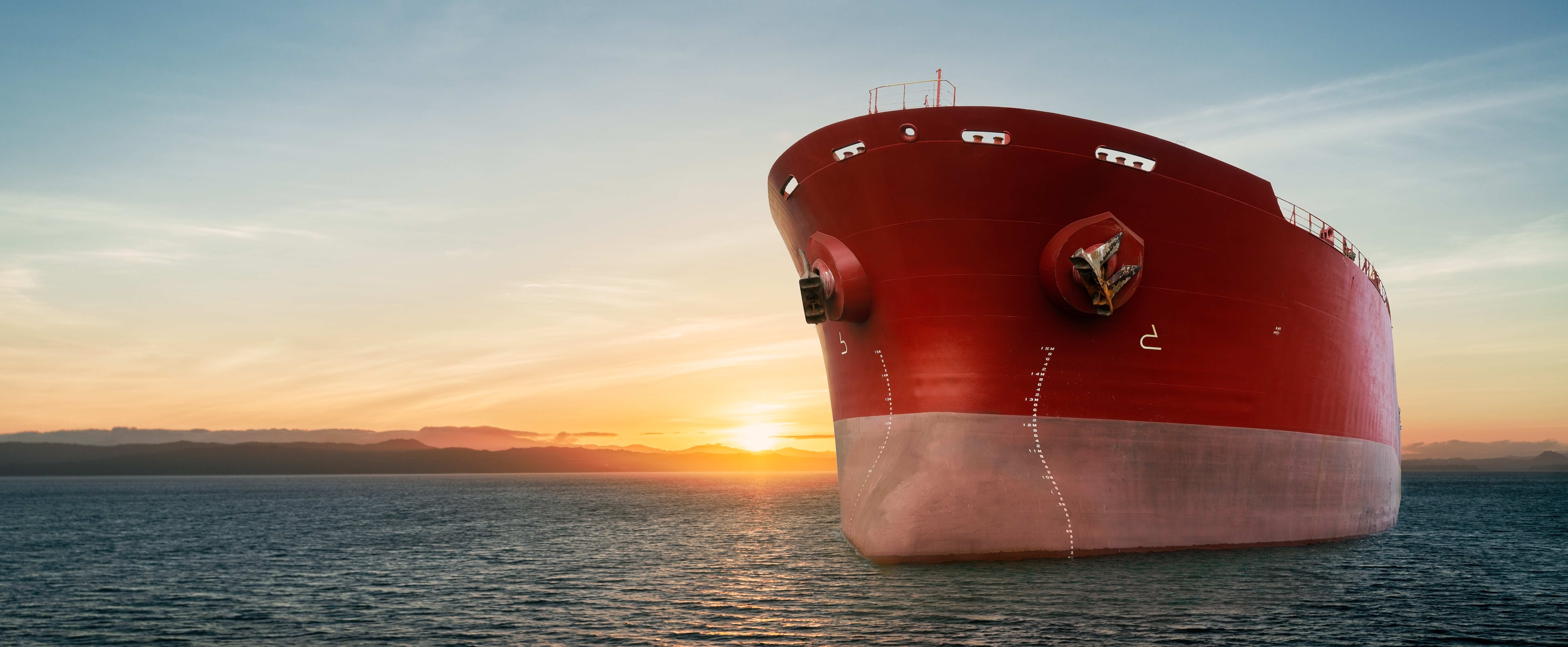 Cargo ship on the water at sunrise